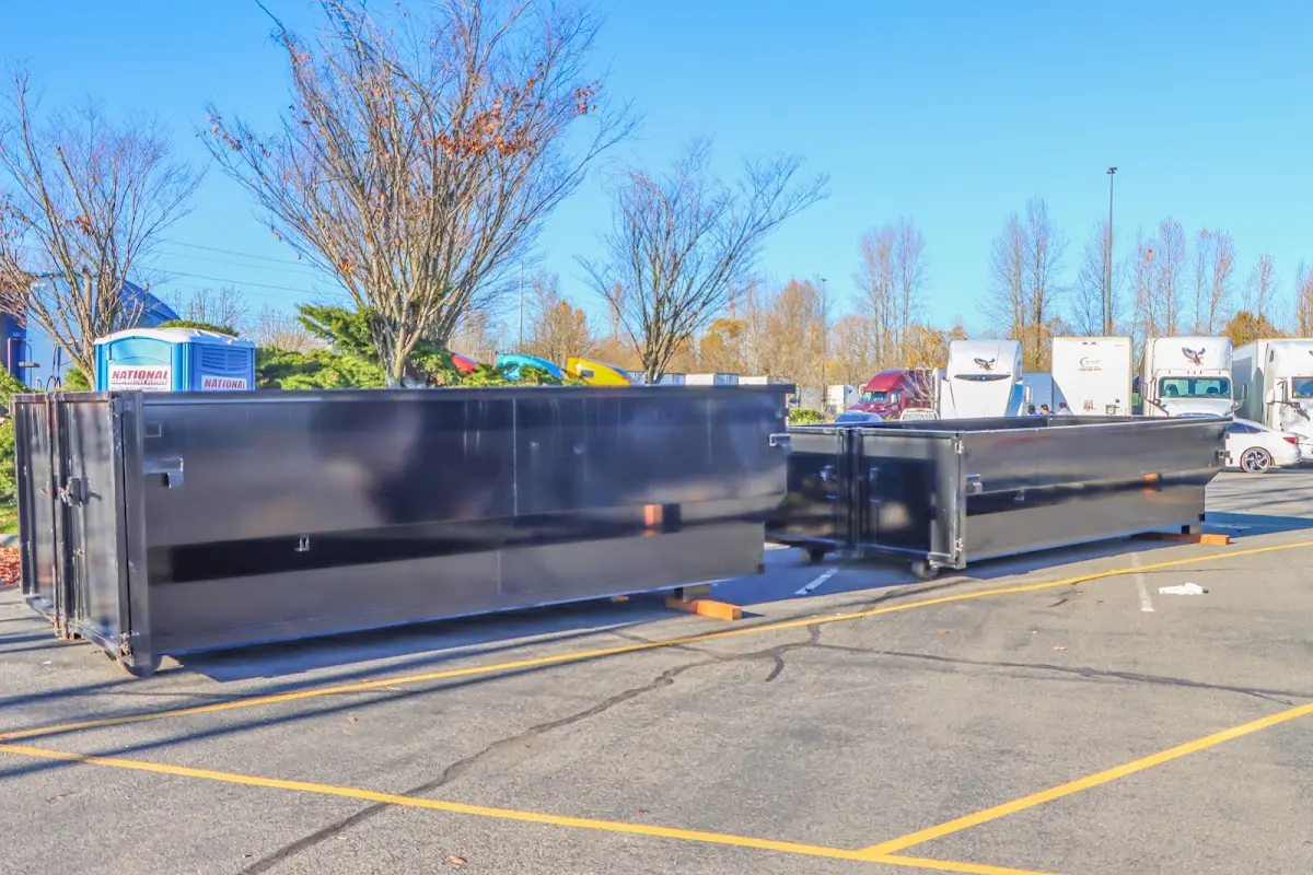 Professional dumpster rental service with roll-off container on residential driveway in Seguin
